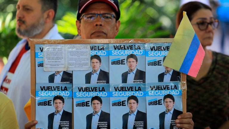 A man holds a sign with propaganda for presidential candidate Miguel Uribe during a protest against violence and in favor of peace in Medellin, Colombia, on June 8, 2025, the day after the attack on Uribe. AFPpix