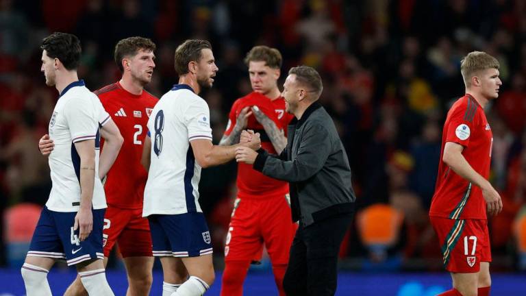 England’s Jordan Henderson shakes hands with Wales manager Craig Bellamy after the match Action Images via Reuters/Peter Cziborra