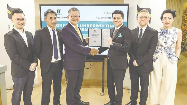 Ng (third from left) and M&amp;A Equity Holdings managing director Datuk Bill Tan, representing M&amp;A Securities, displaying the signed documents.