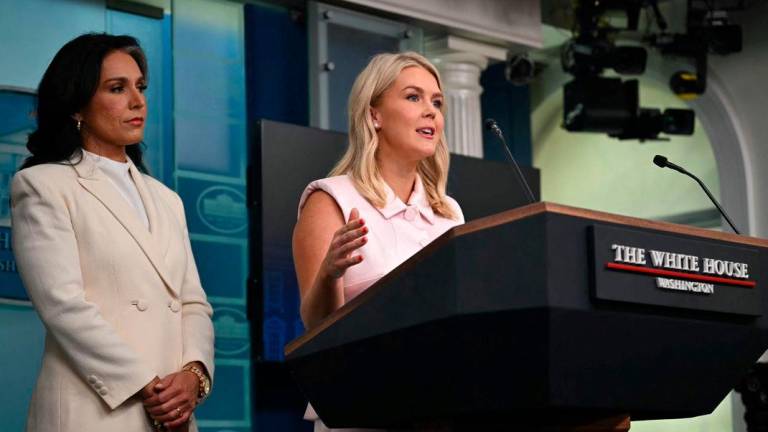 White House Press Secretary Karoline Leavitt speaks as US Director of National Intlligence Tulsi Gabbard looks on during a press briefing in the Brady Briefing Room at the White House - AFPPix