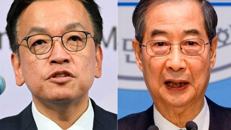This combination of pictures made on May 27, 2025 shows South Korea’s Finance Minister Choi Sang-mok (L and former acting president Han Duck-soo. AFPpix