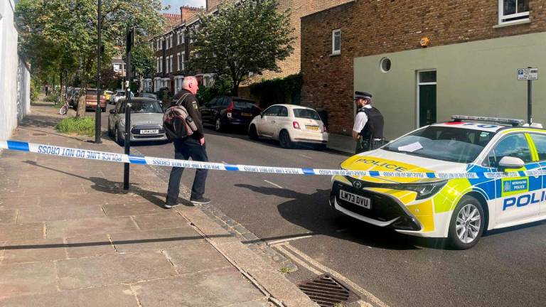 A person walks to a police officer at a cordoned off street, where a fire broke out at Britain's Prime Minister Keir Starmer's home in the early hours of Monday, in north London, Britain, May 12, 2025. - REUTERSPIX