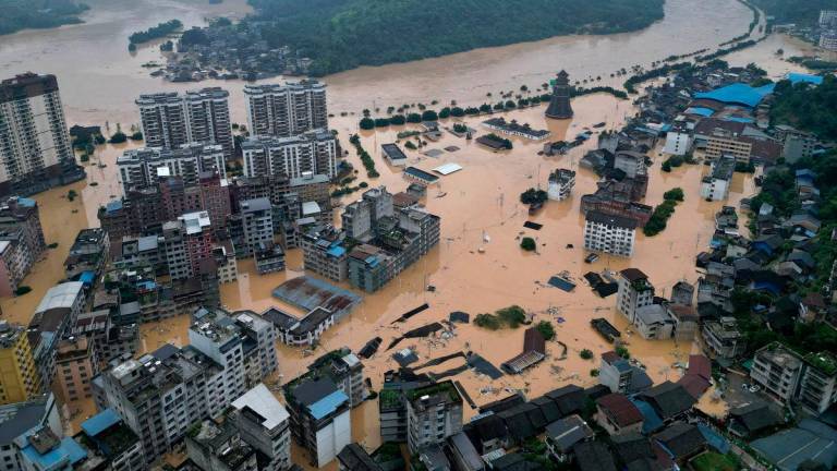 A drone view shows buildings and roads are half submerged in floodwaters after heavy rainfalls, in Rongjiang county, Guizhou province, China June 24, 2025. - REUTERSPIX