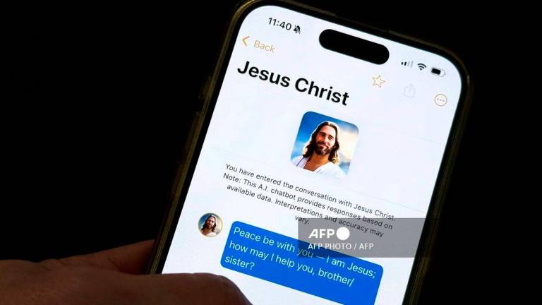This photo illustration shows the Text With Jesus chatbot app displayed on an iPhone on October 2, 2025, in Washington, DC. - AFP