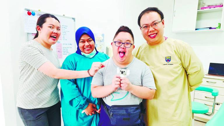 Dr Lynn (first left) ensures all her patients, whether wheelchair-bound or those with learning disabilities feel comfortable.