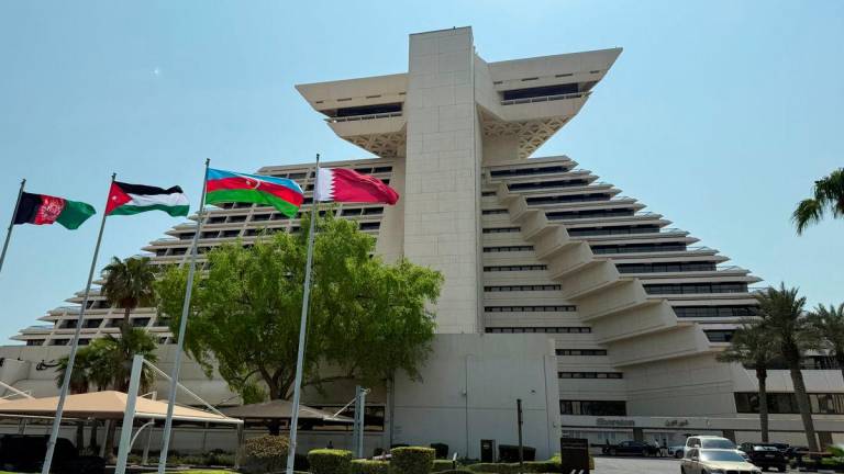 Flags of Afghanistan, Jordan, Azerbaijan and Qatar flutter as Qatar prepares to host the Emergency Arab-Islamic Summit at the Sheraton Hotel, in Doha, Qatar, September 14, 2025. REUTERS/Ibraheem Abu Mustafa
