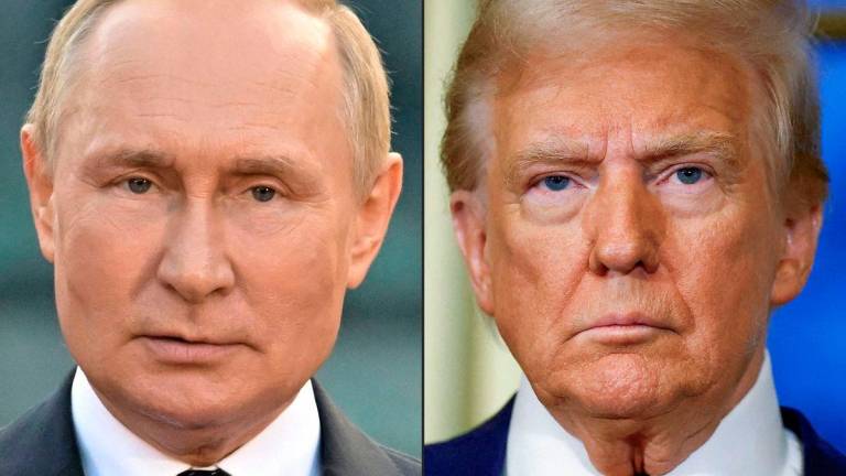 This combination of file photographs created on August 8, 2025 shows Russian President Vladimir Putin (L) giving a speech during an event to mark the 1160th anniversary of Russia’s statehood in Veliky Novgorod on September 21, 2022, and US President-elect Donald Trump looking on during a meeting with France’s President at the Elysee Palace in Paris, on December 7, 2024. Photo by Ilya PITALEV and Sarah Meyssonnier / various sources / AFP