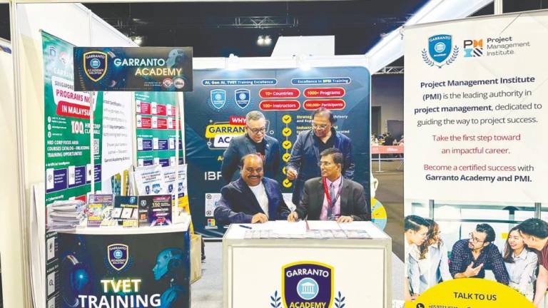 Seated, from left: Sreemann and Mathuraiveran at the MoU signing ceremony.