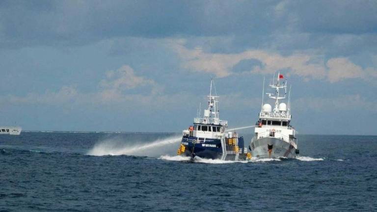 A China Coast Guard vessel 21559 uses a water cannon against Philippines Bureau of Fisheries and Aquatic Resources ship BRP Datu Pagbuaya in the South China Sea, in this handout image released by the Philippine Coast Guard on October 12, 2025. - Philippine Coast Guard/Handout via REUTERSPIX
