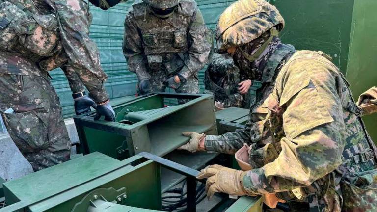 South Korean soldiers work on a loudspeaker that is set up for propaganda broadcasts during a military drill near the demilitarised zone. The Defense Ministry/Handout via REUTERS/File Photo