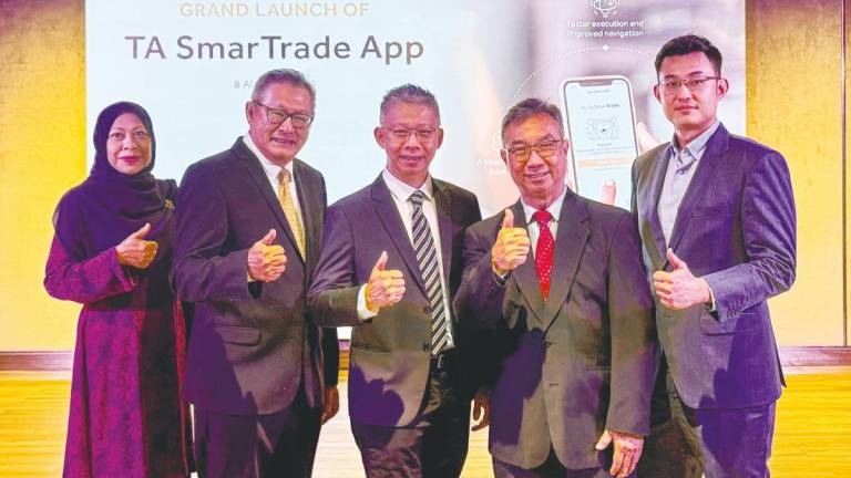 From left: TA Securities Holdings non-independent non-executive director Nor Asma Mohamed, executive director of dealing Datuk Hamzah Mohd Tahir; independent non-executive director Bobby Chew; executive director of operations Tah Heong Beng; and Leong at the official launch of TA SmarTrade.