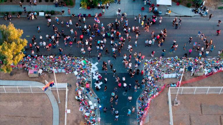 A drone view shows people gathering to pay tribute to slain conservative commentator Charlie Kirk at the headquarters of Turning Point USA, ahead of a memorial service for him which is to be held on September 21, in Phoenix, Arizona, U.S., September 20, 2025. REUTERS/Cheney Orr