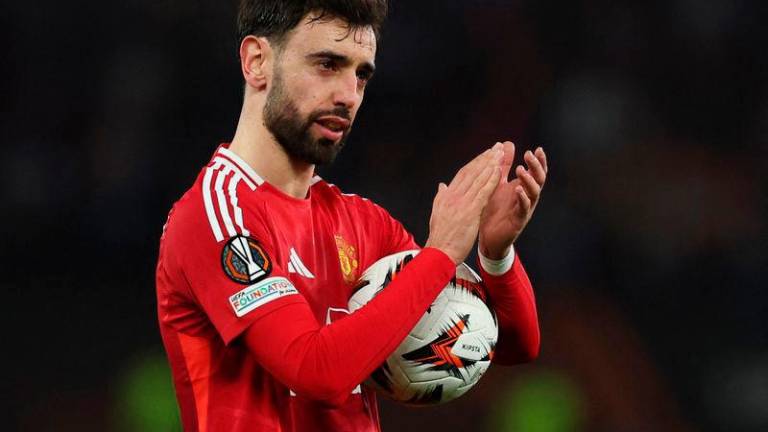 Manchester United’s Bruno Fernandes celebrates with the match ball after the match. REUTERSpix