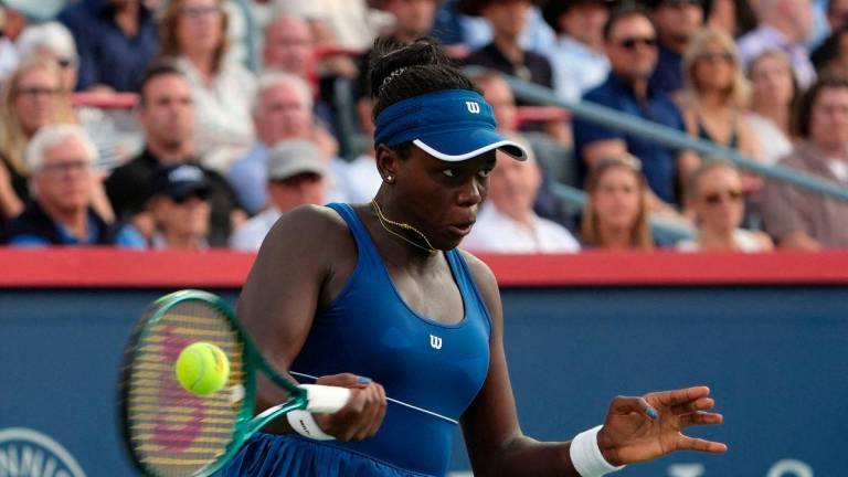 Victoria Mboko (CAN) returns the ball against Elena Rybakina (KAZ) in semifinal play at IGA Stadium. Mandatory Credit: Eric Bolte-Imagn Images