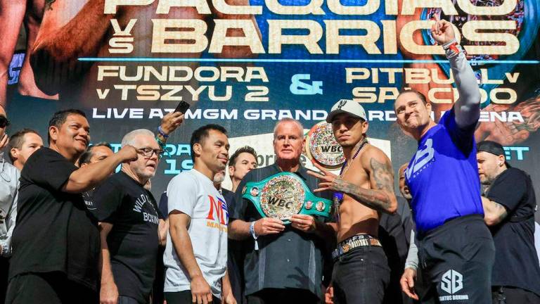 Trainers Buboy Fernandez and Freddie Roach, Manny Pacquiao, TGB Promotions President Tom Brown, WBC welterweight champion Mario Barrios and his head coach Bob Santos pose during a ceremonial weigh-in at MGM Grand Garden Arena - Ethan Miller/Getty Images/AFP