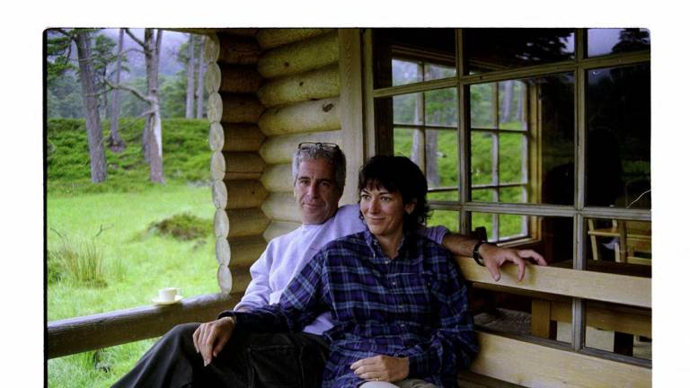 This undated trial evidence image obtained December 8, 2021, from the US District Court for the Southern District of New York shows British socialite Ghislaine Maxwell and US financier Jeffrey Epstein in Queen’s log cabin at Balmoral. - (Photo by Handout / US DISTRICT COURT FOR THE SOUTHERN DISTRICT OF NEW YORK / AFP)