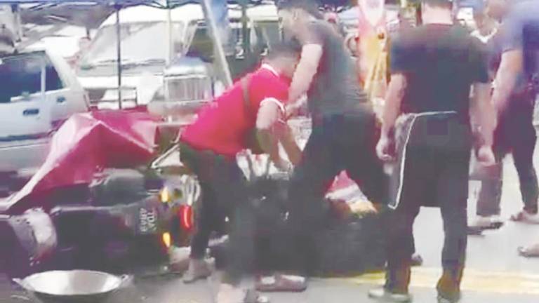 Screenshot from video of incident showing PwD being beaten while lying on ground.