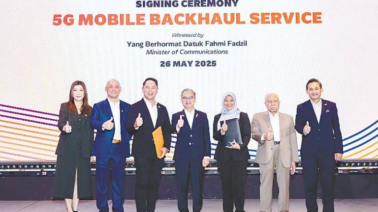 From left: U Mobile chief financial officer Sandy Tsang, Wong, U Mobile chief technology officer Woon Ooi Yuen, Fahmi, TM Global executive vice-president Khairul Liza Ibrahim, TM chairman Datuk Zainal Abidin Putih and TM CEO Amar Huzaimi Md Deris at the partnership signing ceremony.