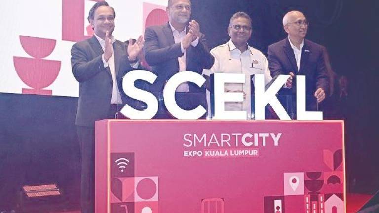 From left: Malaysia Digital Economy Corporation CEO Anuar Fariz Fadzil, Gobind, Digital Ministry Deputy Secretary General (Digital Development) MA Sivanesan Marimuthu and Digital Nasional Bhd CEO Datuk Azman Ismail at the launch of the 100-day countdown to Smart City Expo Kuala Lumpur 2025.