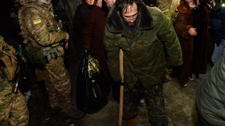 Ukraine, rebels swap dozens of prisoners