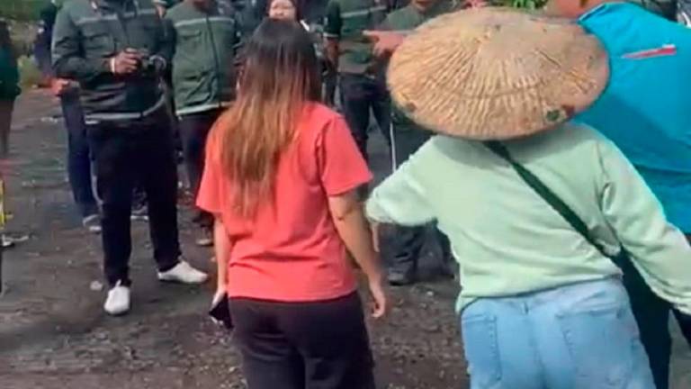 A forestry enforcement team and Penan residents in heated confrontation at a protest in the Long Tepen forest of Baram.