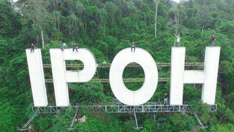 Group that climbed 'Ipoh' signboard apologise