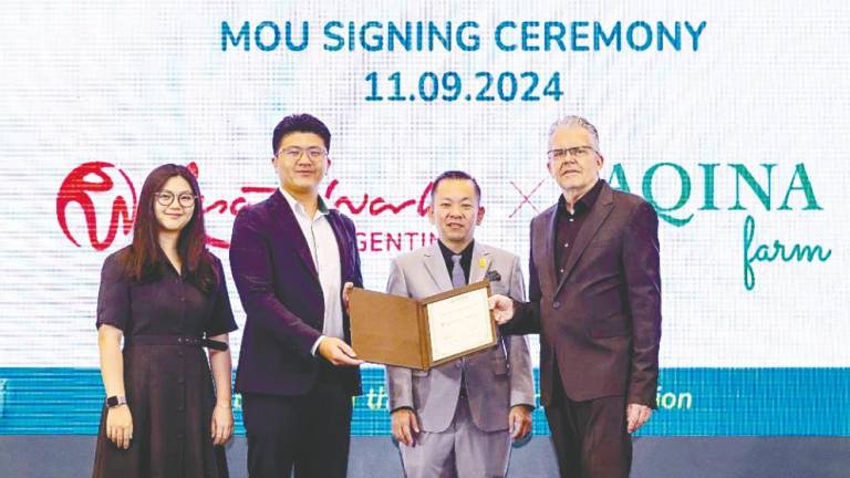 Chan (third from left), Tan (second from left) and RWG executive vice-president of leisure, hospitality and lifestyle Peter Foster at the signing ceremony.