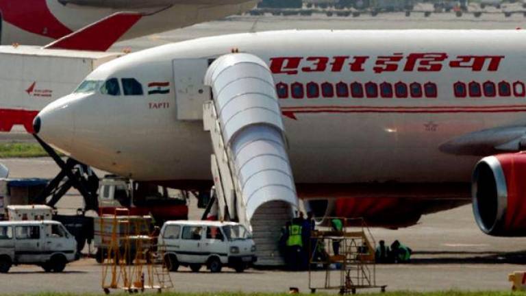 Air India aircrafts stand on the tarmac at the airport in Mumbai September 27, 2009. State-run Air India will cut productivity linked incentives payable to its employees by up to 50 percent, in a cost cutting measure affecting over 7,000 of its employees. - REUTERSPIX/Punit Paranjpe (INDIA TRANSPORT EMPLOYMENT BUSINESS)