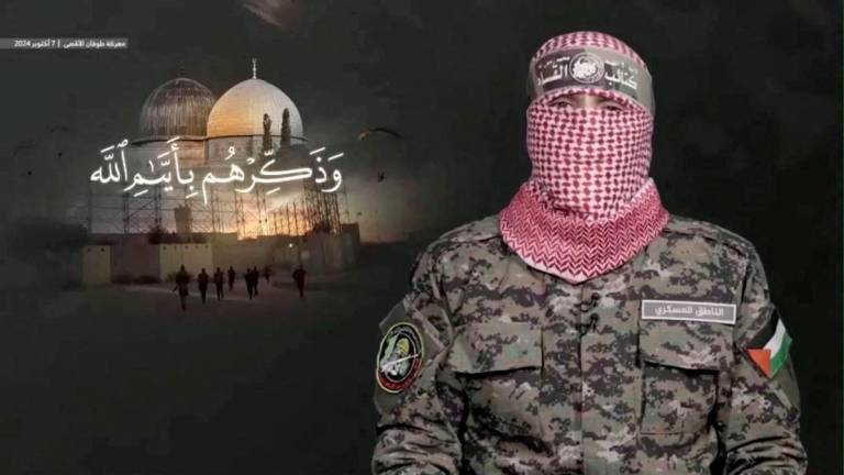 FILE PHOTO: A masked person said to be Abu Ubaida, the military spokesperson of Hamas’ armed wing, the al-Qassam Brigades, speaks commemorating the one year anniversary of the October 7, 2023 attack against Israel, at a location given as Gaza, in this screengrab from handout video released October 7, 2024. Hamas Armed Wing Media/Handout via REUTERS/File Photo