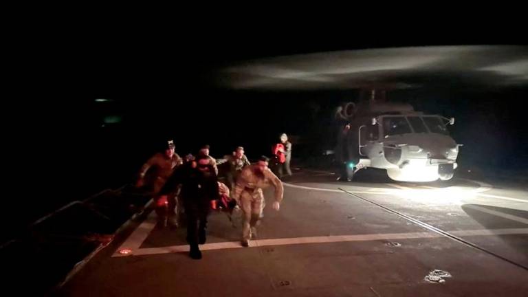 Personnel from EU maritime mission Eunavfor Aspides' transport a casualty during rescue operation following an attack by Yemen's Houthi on the Dutch-flagged general cargo ship Minervagracht, which caught fire in the Gulf of Aden on Monday, in this screengrab taken from handout video released on September 30, 2025. - Eunavfor Aspides via X/Handout via REUTERSPIX