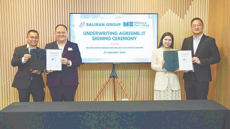 From left: Saliran Group Bhd executive director Chan Koon Wai, Liaw, Malacca Securities Sdn Bhd managing director Lim Chia Wei and co-head of corporate finance Jason Chan.