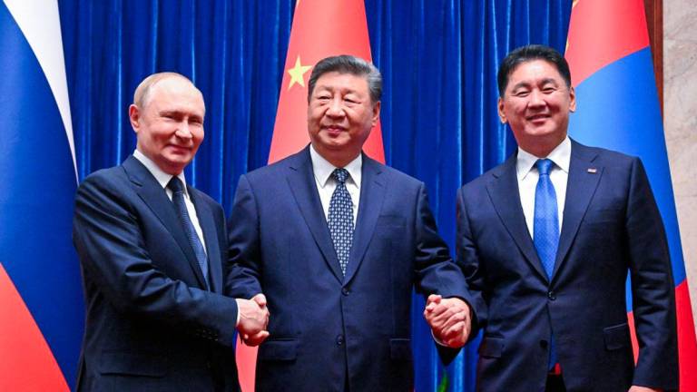 Russian President Vladimir Putin, Chinese President Xi Jinping and Mongolian President Ukhnaagiin Khurelsukh pose for a picture before a meeting in Beijing, China September 2, 2025. - Sputnik/Sergey Bobylev/Pool via REUTERSPIX