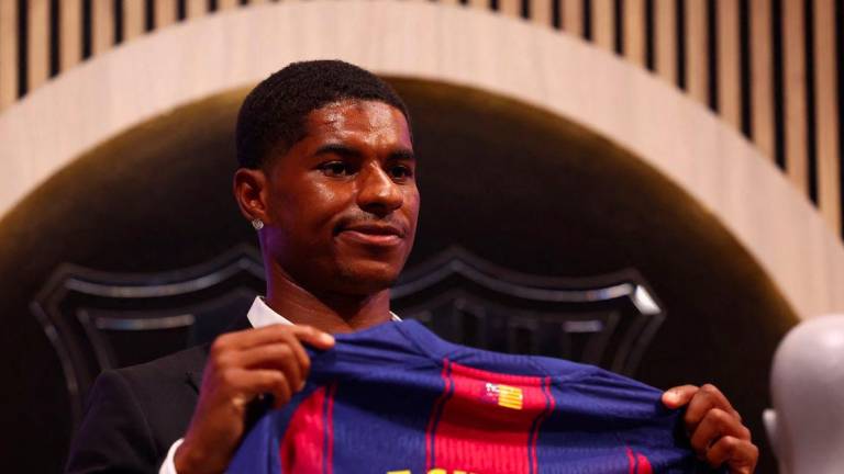 Football - FC Barcelona present new player Marcus Rashford - FC Barcelona Club Shop, Barcelona, Spain - July 23, 2025Barcelona's new signing Marcus Rashford poses with his shirt during the presentation - REUTERSPIX