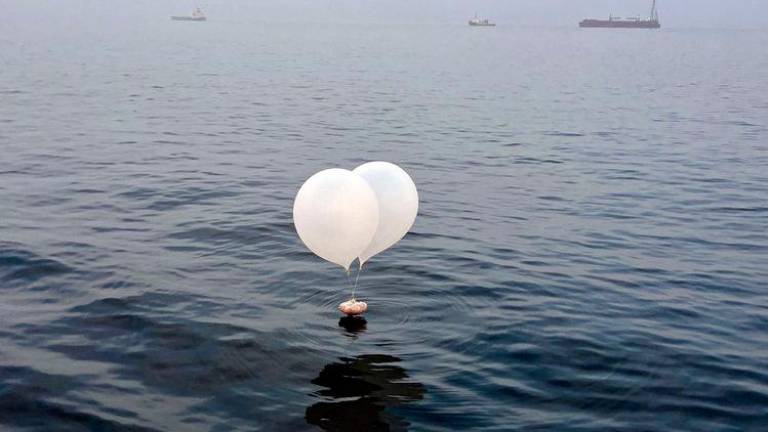 A balloon carrying various objects including what appeared to be trash, believed to have been sent by North Korea, is pictured at the sea off Incheon, South Korea - REUTERSpix