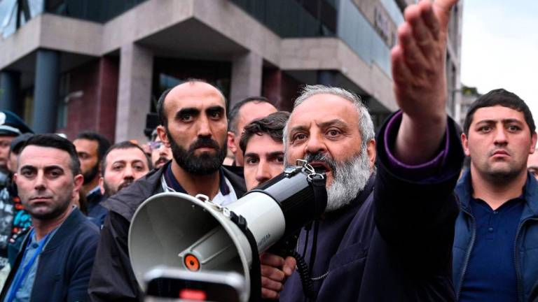 Protest leader Archbishop Bagrat Galstanyan addresses demonstrators during a protest against land transfer to neighbouring Azerbaijan, in Yerevan on May 15, 2024. (Photo by KAREN MINASYAN / AFP)