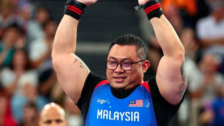 Paris 2024 Paralympics - Powerlifting - Men's 97kg Final - Porte de La Chapelle Arena, Paris, France - September 7, 2024 Nicodemus Manggoi Moses of Malaysia gestures - REUTERSPIX