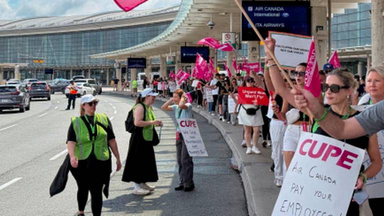Demonstrators holds placards and flags, as Air Canada flight attendants said they will remain on strike and challenge a return-to-work order they called unconstitutional, defying a government decision to force them back to their duties, at Toronto Pearson International Airport in Mississauga, Ontario, Canada August 17, 2025. - REUTERSPIX