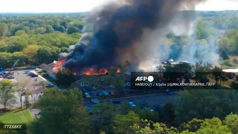 This frame grab from UGC drone footage obtained from “X/Julie J/@MALKOWSKI6APRIL” shows a fire at a Church of Jesus Christ of Latter-day Saints in Grand Blanc Township, Michigan on September 28, 2025. AFP PHOTO / X/JULIE J/@MALKOWSKI6APRIL / HANDOUT