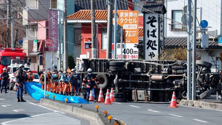 Rescue operations continue for a truck driver after his vehicle was swallowed up by a sinkhole at a prefectural road intersection the day before, in the city of Yashio, Saitama Prefecture on January 29, 2025. Photo by JIJI PRESS / AFP