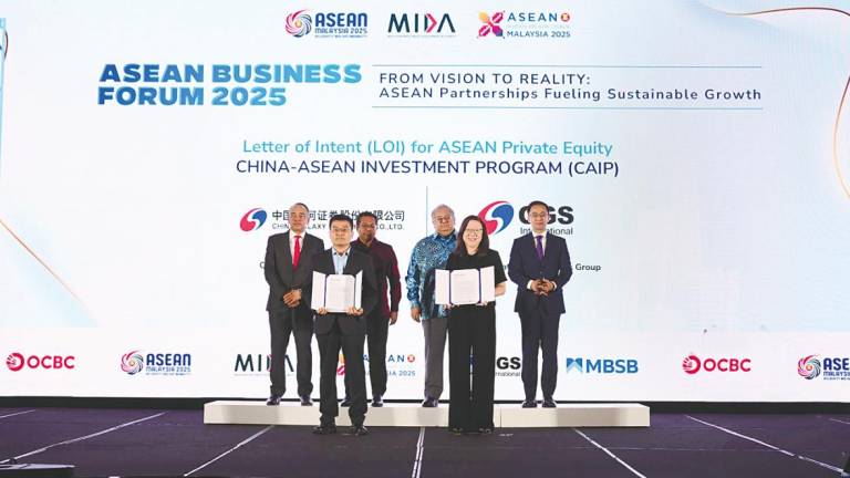 From left: Nazir, CGS strategic development headquarters member of executive committee, business director and general manager Zhang Ruibin; Sikh Shamsul Ibrahim, Mohammad Faiz, Fong and Wang with the signed LoI for the China-Asean Investment Programme.