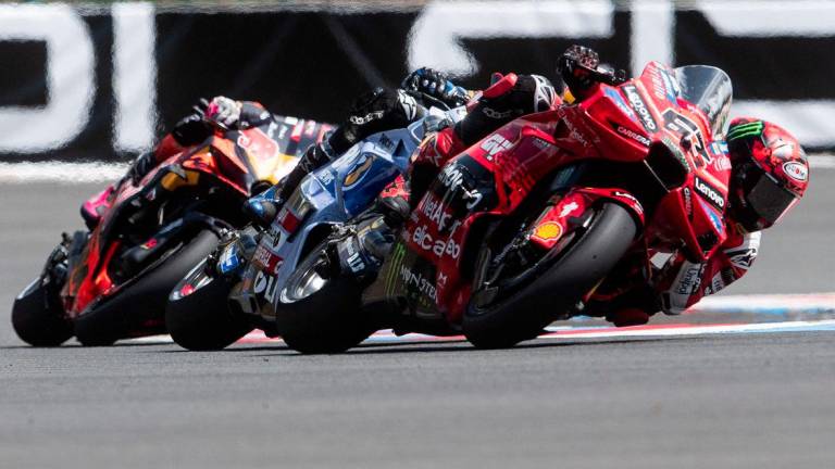 Ducati Lenovoi Team's French MotoGP rider Francesco Bagnaia (1st R) competes during the qualifying of motorcycle Czech Moto GP Grand Prix at the Masaryk circuit in Brno, Czech Republic on July 19, 2025. - AFPPIX