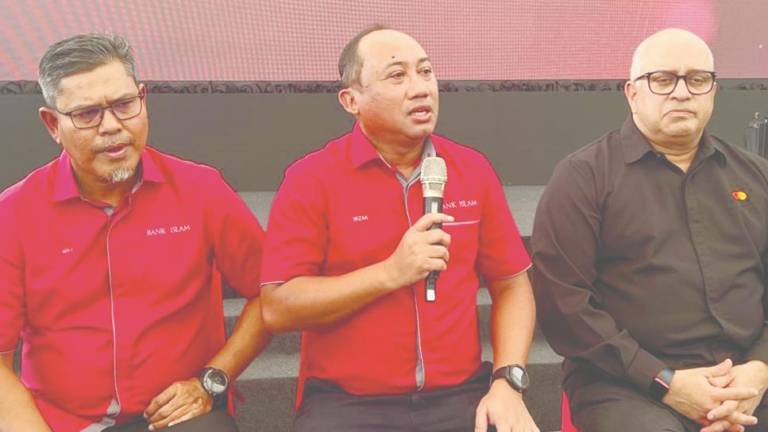 From left: Bank Islam head of deposit and cash management Mohd Noor Jab, Mizan and Mastercard Malaysia account management vice-president Devesh Kuwader at a press conference in conjunction with the launch of the Bank Islam Mastercard Debit Card-i.