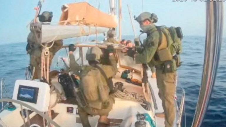 A screengrab from a live stream video shows people in uniform aboard the Gaza-bound vessel Oxygono, part of the Global Sumud Flotilla, which flotilla organisers report has been intercepted, October 2, 2025. - Global Sumud Flotilla/Handout via REUTERS