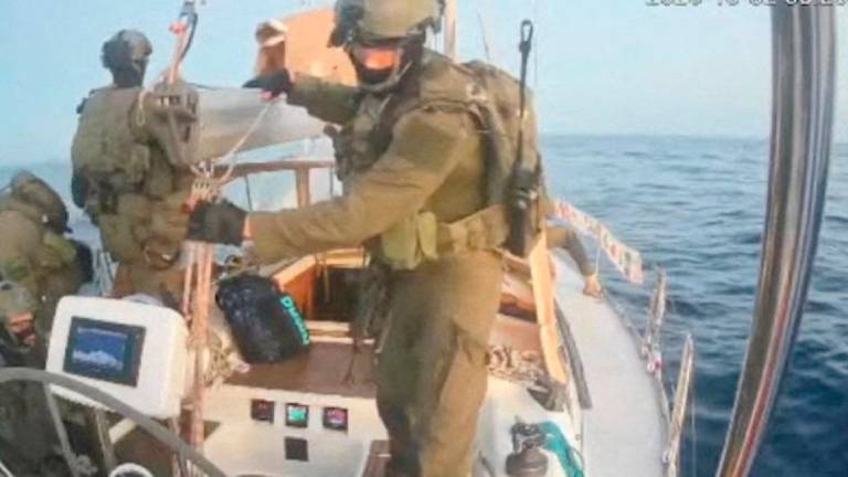 A screengrab from a live stream video shows people in uniform aboard the Gaza-bound vessel Oxygono, part of the Global Sumud Flotilla, which flotilla organisers report has been intercepted, October 2, 2025. - Global Sumud Flotilla/Handout via REUTERS