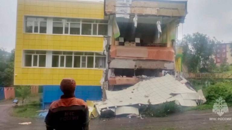 Am emergency services worker looks at a kindergarten damaged by an earthquake, in Petropavlovsk-Kamchatsky, Kamchatka Krai, Russia, July 30, 2025 in this screen grab from handout video. - Russian Ministry for Emergencies/Handout via REUTERSPIX