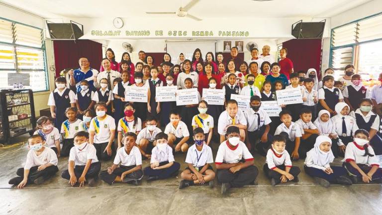 Pupils and staff of a recipient school in Ipoh during the cheque presentation/Pix credit: BERJAYA CORP