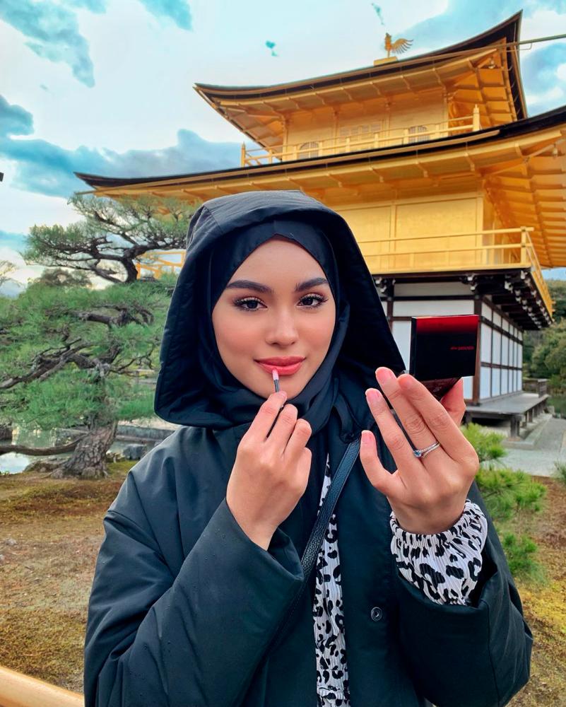 Influencer caught in a storm after pictured without headscarf