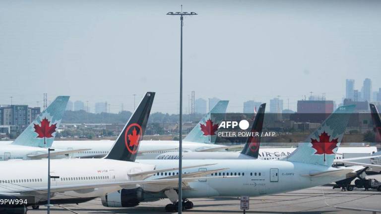 Air Canada airplanes stand on the tarmac at Pearson International Airport in Toronto on August 16, 2025. Air Canada cancelled hundreds of flights Saturday as it began shutting down operations in response to a strike by flight attendants -- triggering summer travel chaos for its 130,000 daily passengers. Canada's largest airline, which flies directly to 180 cities worldwide, urged customers not to go to the airport if they have a ticket for Air Canada or its lower-cost subsidiary Air Canada Rouge. - Peter POWER / AFP
