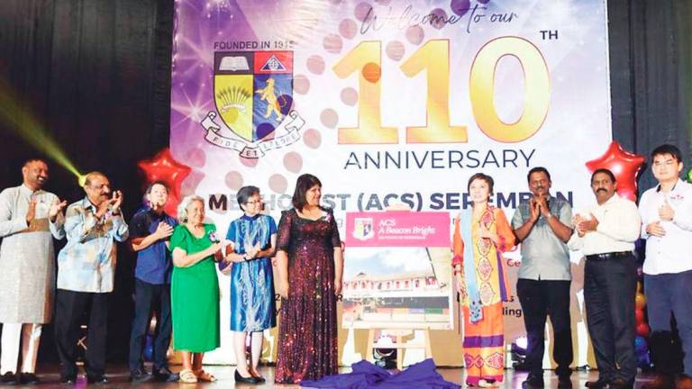 Tan (4th right) launches the book while Indrani (5th right), Rebecca (4th left), Ron (left) and other special guests look on.