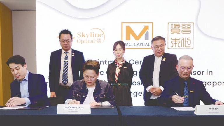 From left: Evolve Capital Pte Ltd partner Andy Chi, Chan and Lin at a signing ceremony in Kuala Lumpur.